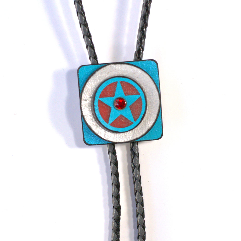 One-of-a-kind turquoise and rose colored bolo with three ruby crystals. Black and white leather cord with silver tips