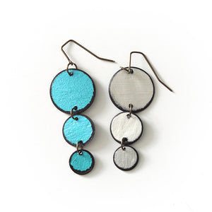 Open image in slideshow, lightweight hypoallergenic circle metallic painted rawhide dangle earrings, handmade in Wyoming, turquoise and silver
